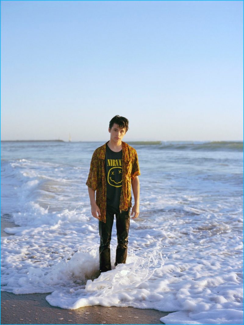 Hitting the beach, Dylan Jagger Lee is captured in a shirt and jeans from Saint Laurent by Hedi Slimane.