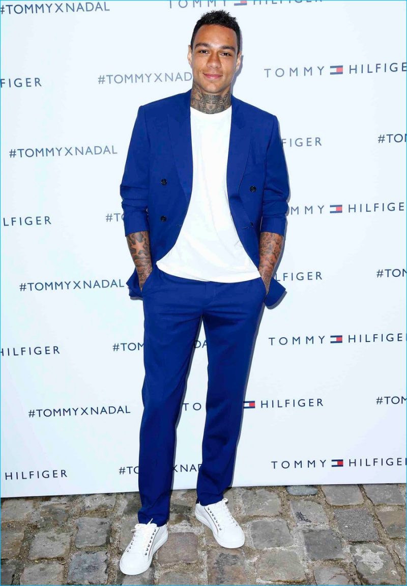 Gregory van der Wiel sports a royal blue Tommy Hilfiger suit with white sneakers.
