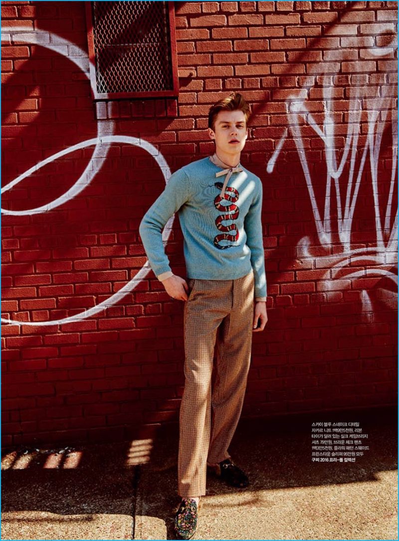 Janis Ancens charms in a blue snaked adorned sweater from Gucci.