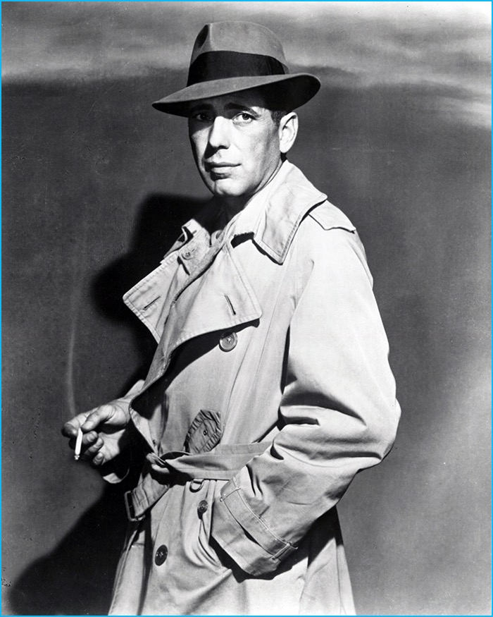 Humphrey Bogart dons his iconic trench coat and fedora as Rick Blaine in Casablanca.