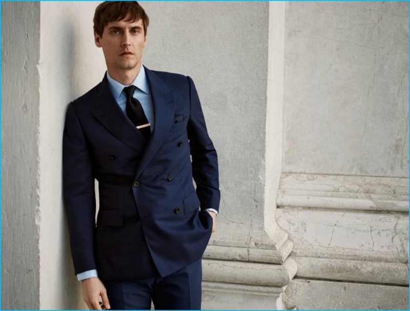 Sebastien Andrieu dons a navy double-breasted wool suit from Kingsman.