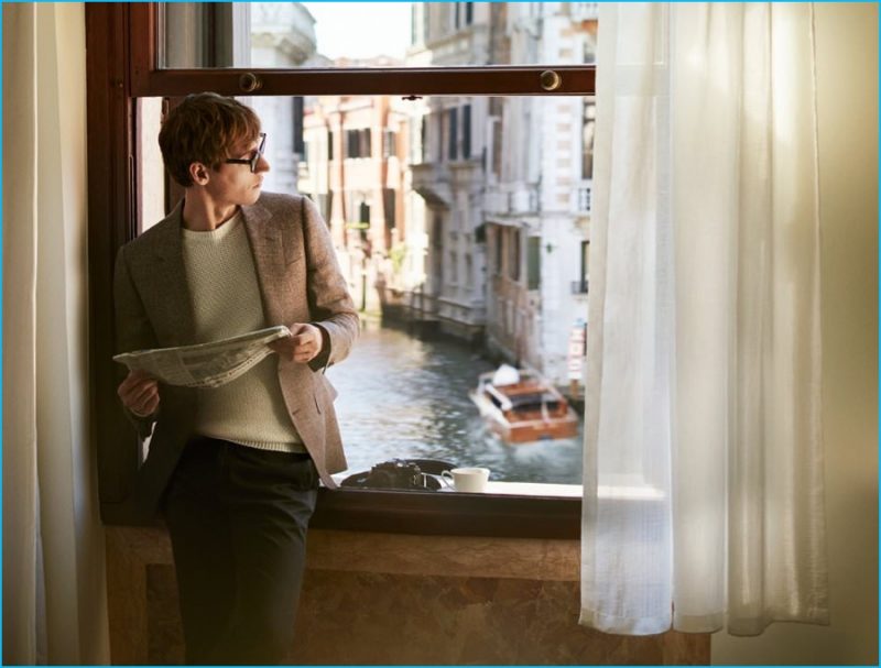 Sebastien Andrieu goes for a smart casual look in a linen and wool blend blazer with a linen sweater, Cutler and Gross square-frame optical glasses and slim-fit trousers from Kingsman.