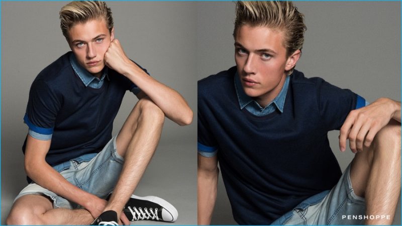 Lucky Blue Smith embraces casual preppy style in a t-shirt, layered with a denim shirt and shorts.