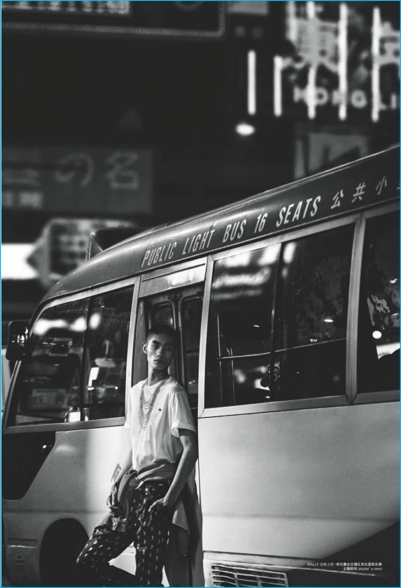 Gong is captured in a black & white image, wearing Bally fashions.