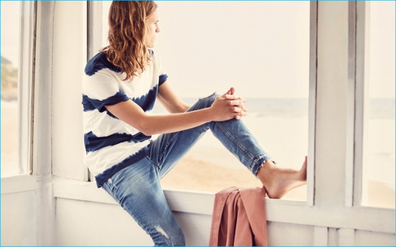 Looking out at his horizons, Malcolm Lindberg is captured in a tie-dye t-shirt with distressed denim jeans from Mango.