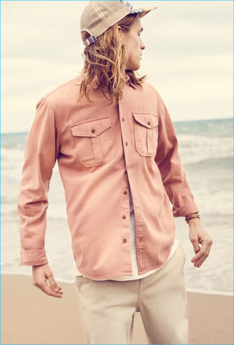 Malcolm Lindberg plays it cool for summer in a two-pocket shirt, pants and a cap from Mango.