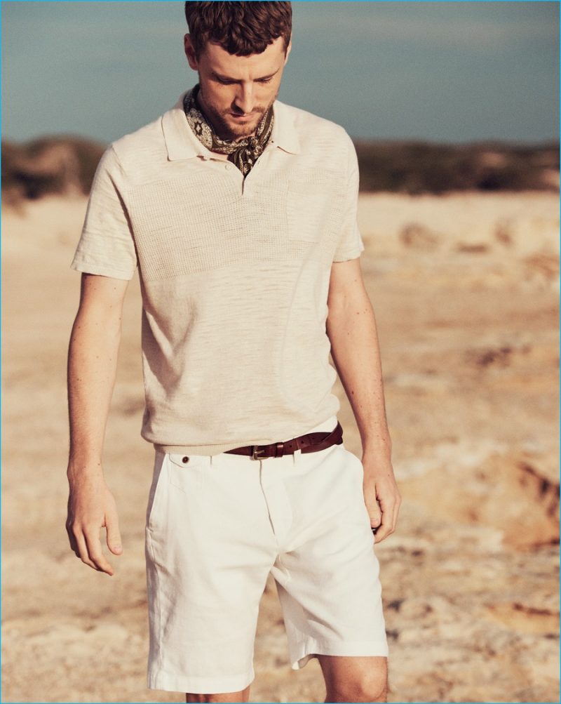 George Barnett sports a safari color theme in a Mango Man polo shirt with Bermuda shorts, a scarf and leather belt.