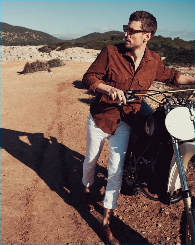 George Barnett pictured in a suede overshirt with white denim jeans, sunglasses and shoes from Mango Man.