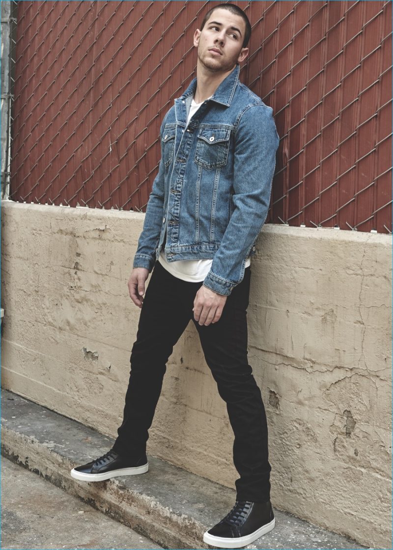 Nick Jonas sports a denim jacket as he connects with Topman.