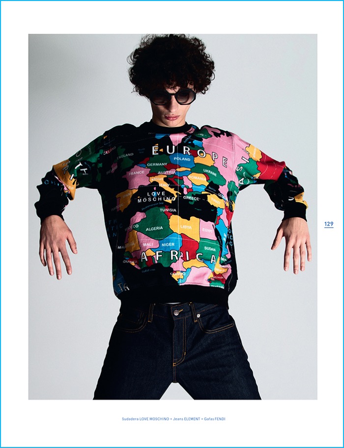 Rocking Fendi sunglasses and Element jeans, Piero Mendez embraces a global flair in a graphic Love Moschino sweatshirt.