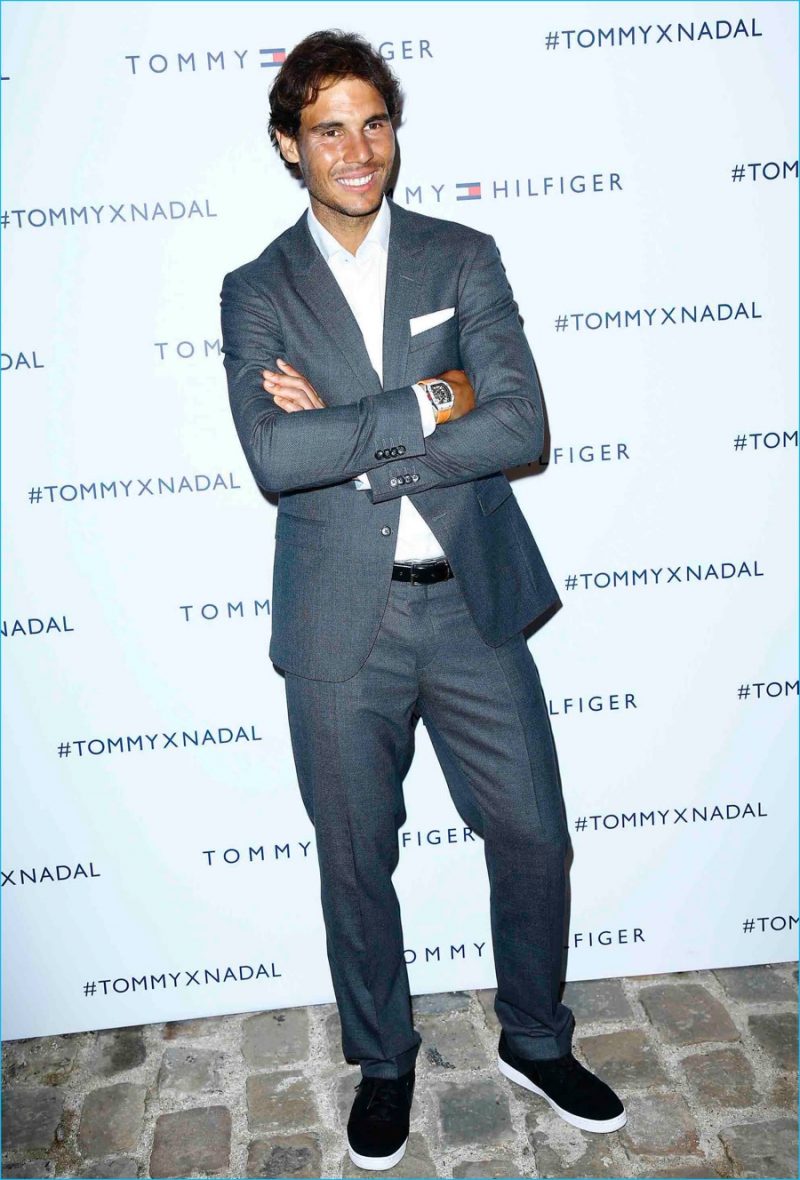 Rafael Nadal dons grey suiting as he poses for pictures at Tommy Hilfiger's pop-up tennis tournament.