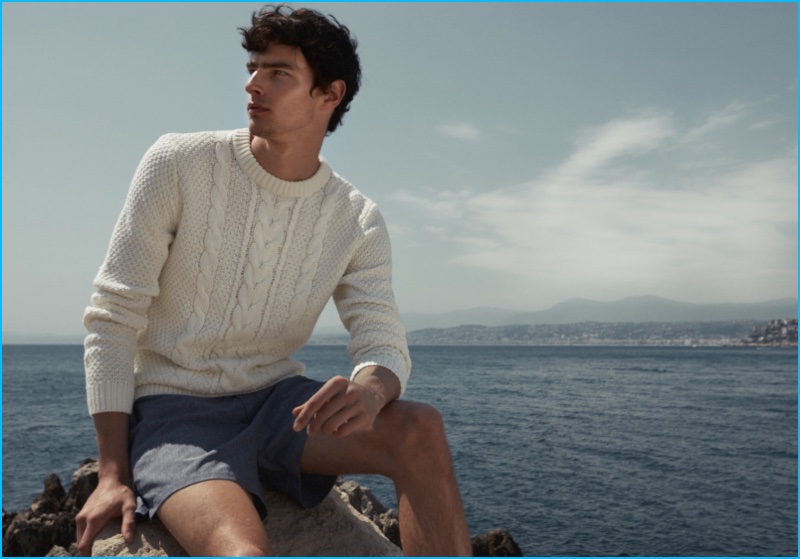 Hannes Gobeyn dons a Reiss cable knit sweater and Ibiza shorts.