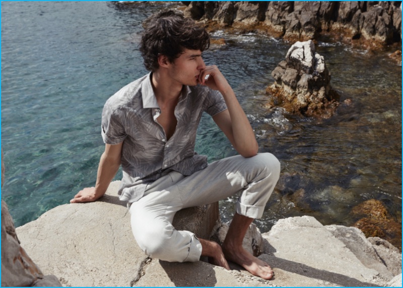 Hannes Gobeyn wears a subtle graphic look from Reiss, sporting a Palmetta short-sleeve shirt with stone trousers.