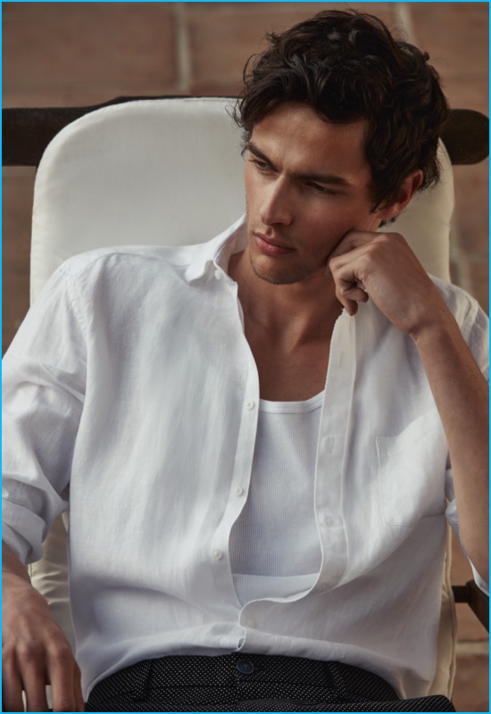 Hannes Gobeyn wears a classic white linen shirt with micro dot shorts from Reiss.