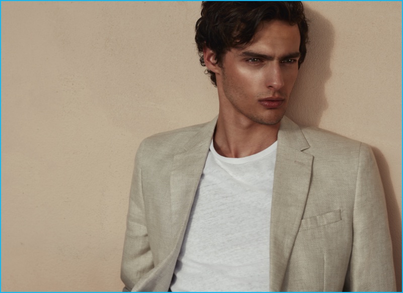 Hannes Gobeyn goes the way of summer neutrals in a natural hued blazer and relaxed t-shirt from Reiss.