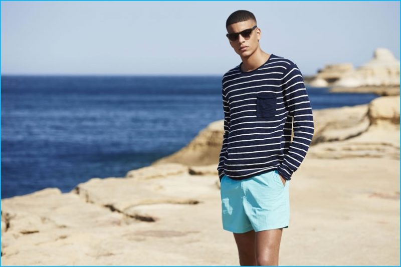 Zakaria Khiare sports a striped pullover with turquoise swim shorts for River Island's high summer campaign.