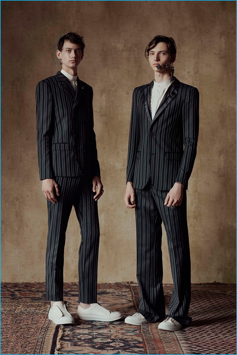 Alexander McQueen juxtaposes its dark striped suiting with white sneakers for spring-summer 2017.