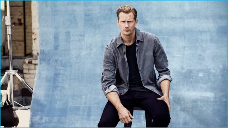 Alexander Skarsgård wears jacket McQ Alexander McQueen, t-shirt James Perse and black denim jeans Brioni.