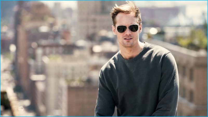 Alexander Skarsgård wears sweatshirt J.Crew and sunglasses Saint Laurent.