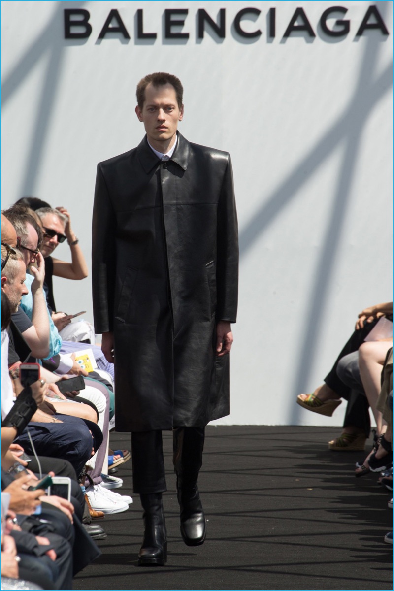 Balenciaga has a minimal moment with a long and wide black leather coat.