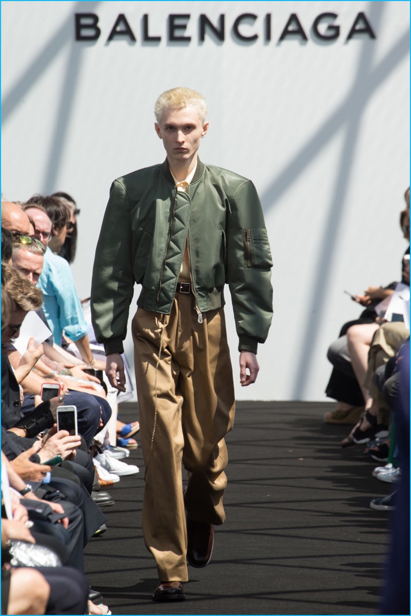 Balenciaga channels military style with a cropped bomber jacket and baggy trousers.