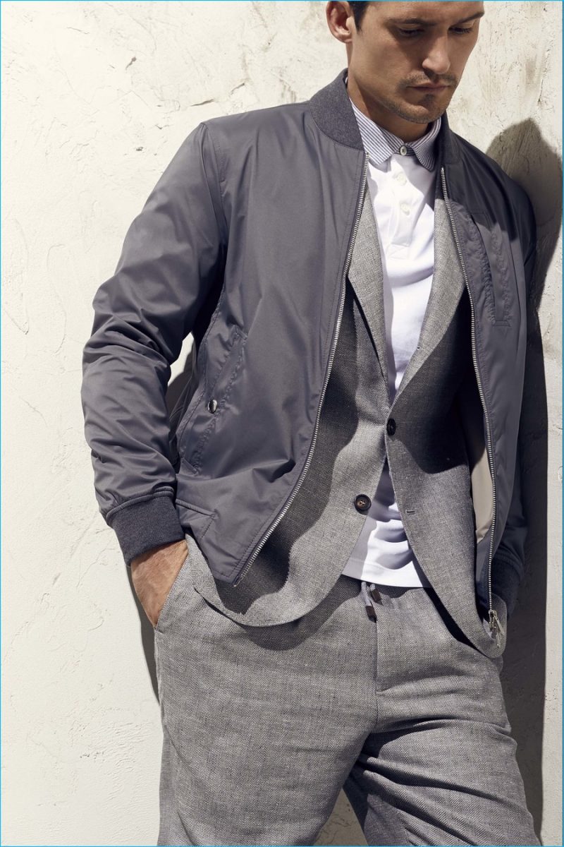 Cool greys are brought together with a nylon bomber jacket signaling the juxtaposition of casual and formal.