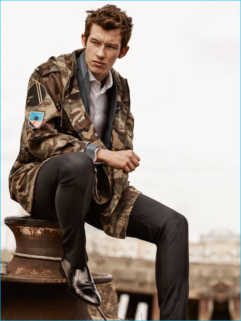 Callum Turner has a camouflage moment in a Saint Laurent by Hedi Slimane jacket.