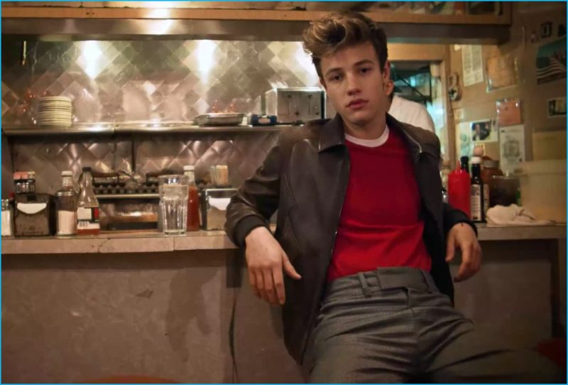 Cameron Dallas wears a leather Harrington jacket with a knit t-shirt and trim trousers from Neil Barrett.