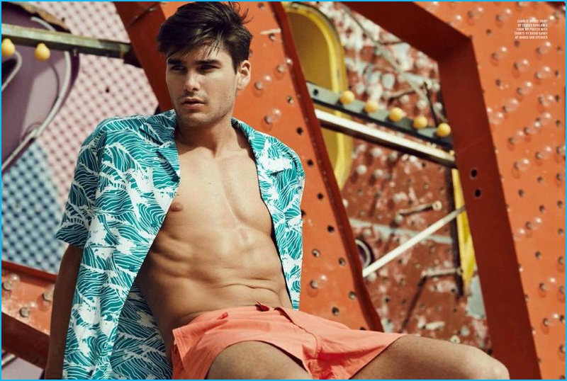 Charlie Matthews sports a Hawaiian print shirt with swim shorts.