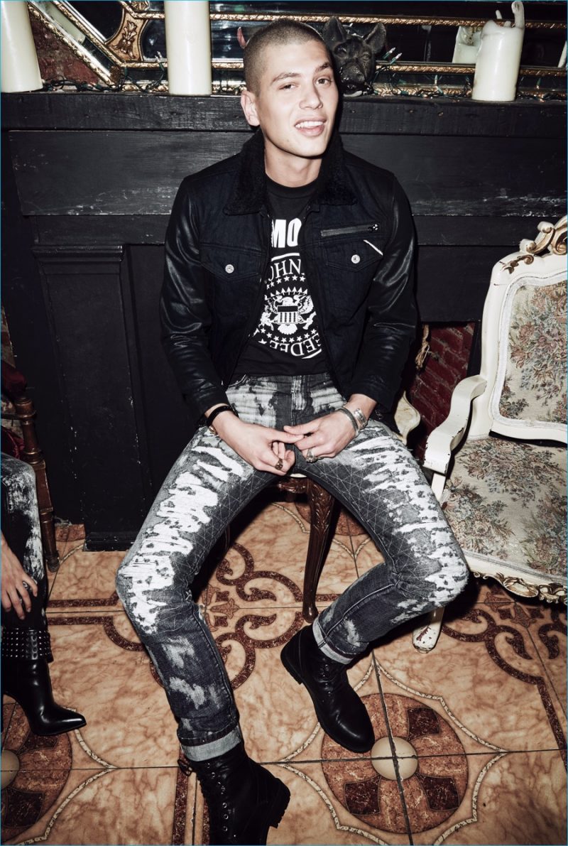 Francesco Cuizza is front and center in destroyed denim jeans and a leather sleeved jacket from Cult of Individuality.
