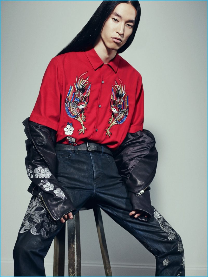 Wataru Shimosato sits for a photo, wearing Diesel's pre-fall 2016 denim jeans, adorned with a skull motif.