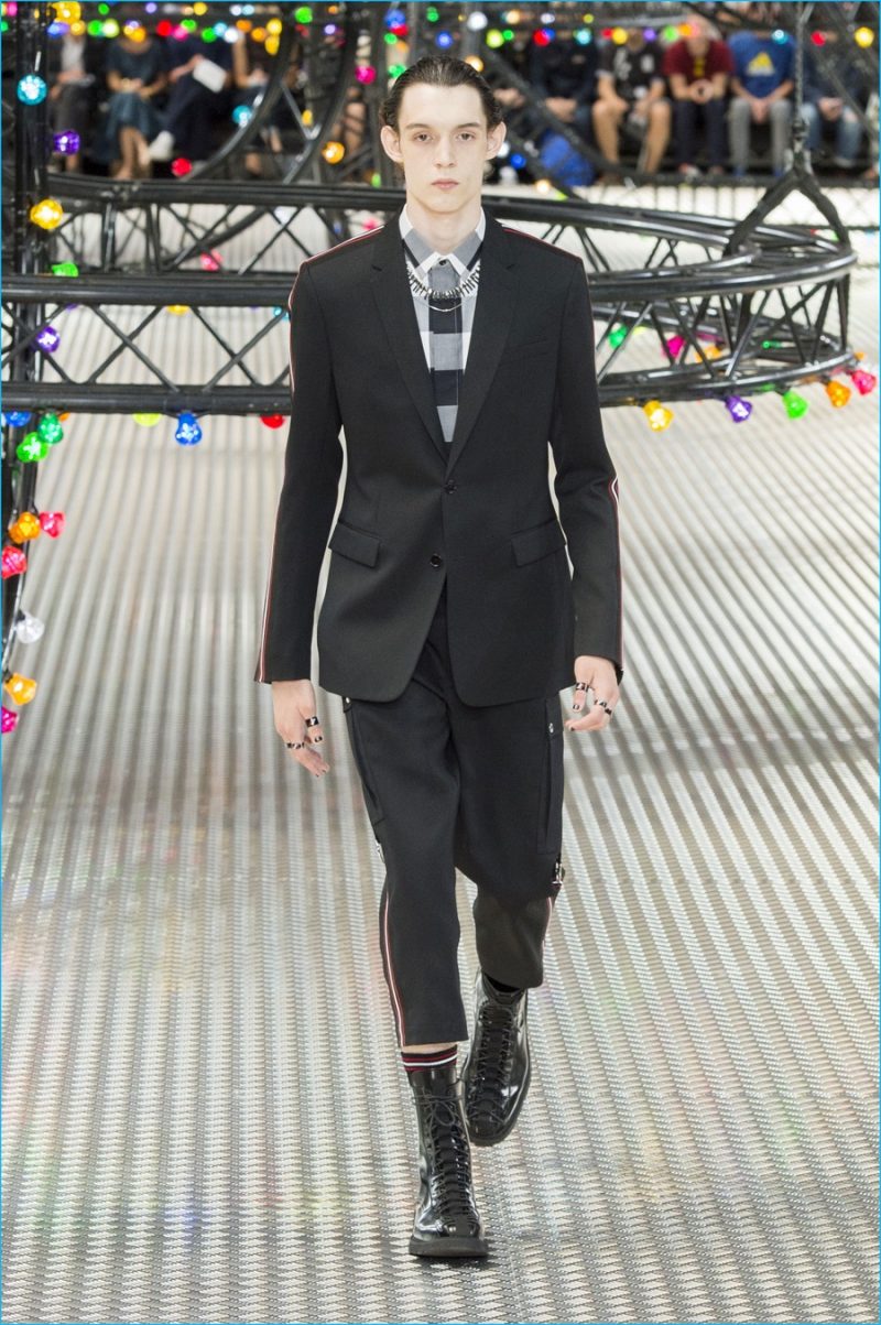 Dior Homme opens the season with a black suit that's updated with sporty bar stripes. 