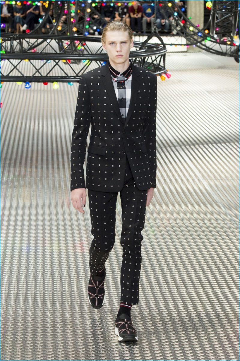 Dior Homme updates a trim black suit with all-over eyelets.