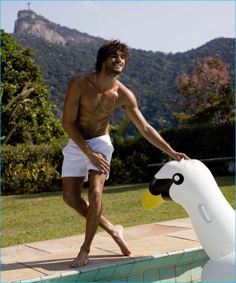 Marlon Teixeira charms in a picture with an inflatable swan for Harper's Bazaar España.