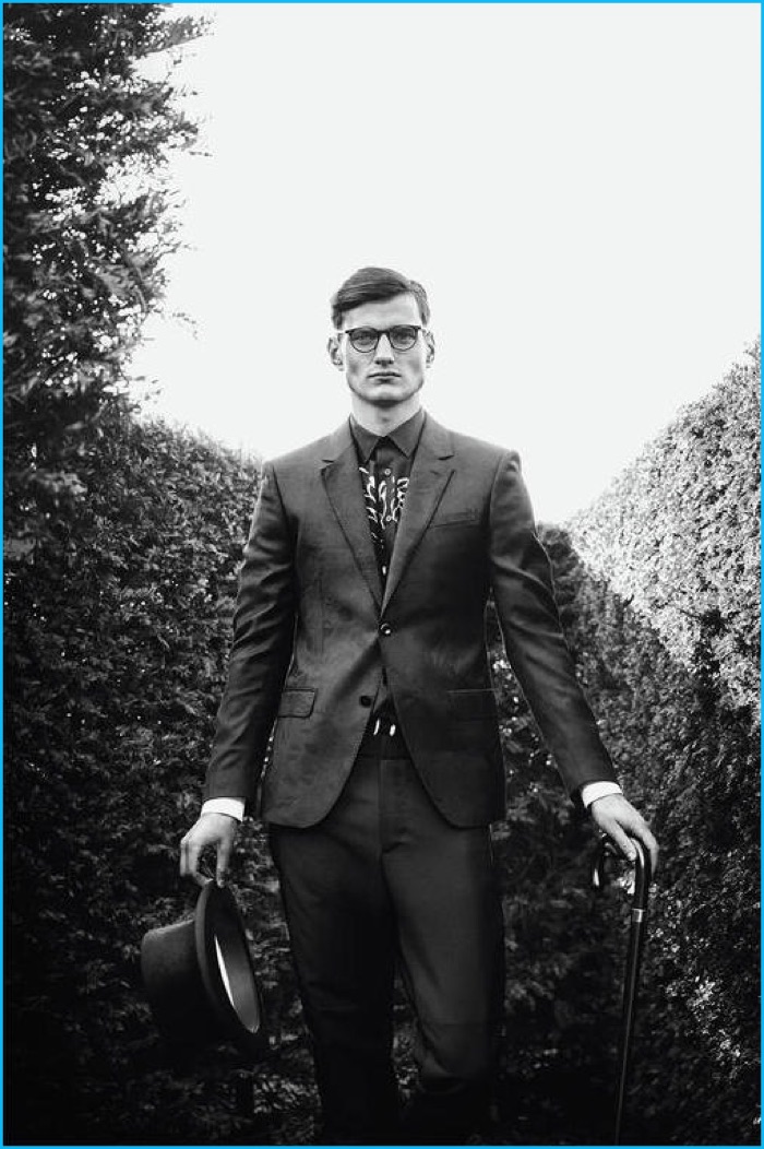 Jack Holland wears jacket and shirt Alexander McQueen, trousers Balenciaga, top hat Christys', Wildman glasses Oliver Peoples and cane Harrods of London.