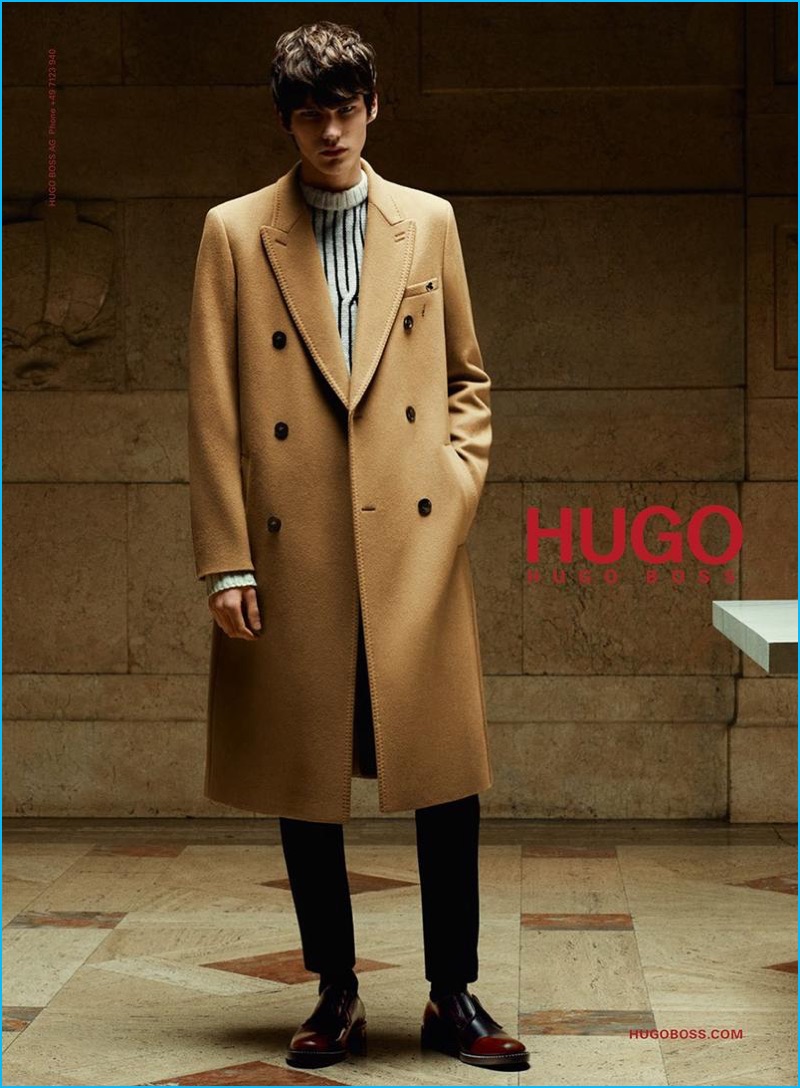 Elias de Poot dons a dashing double-breasted camel coat with a graphic sweater for Hugo Hugo Boss' fall-winter 2016 campaign.