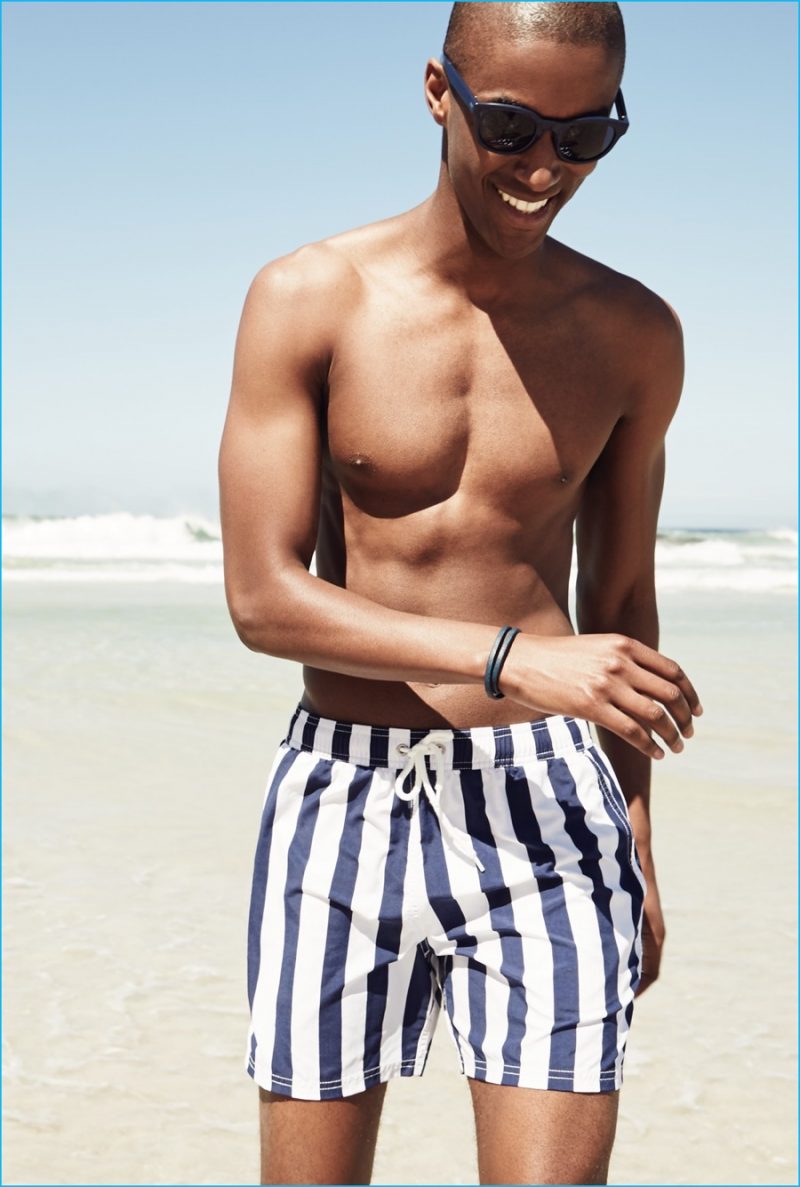 Claudio Monteiro wears white and navy J.Crew striped swim trunks.