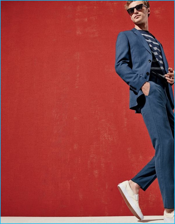 Clément Chabernaud dons a slim Ludlow suit with sneakers, sunglasses and a striped pullover from J.Crew.