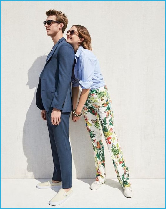 Clément Chabernaud embraces chic summer style in a blue J.Crew suit with sunglasses and slip-on sneakers.