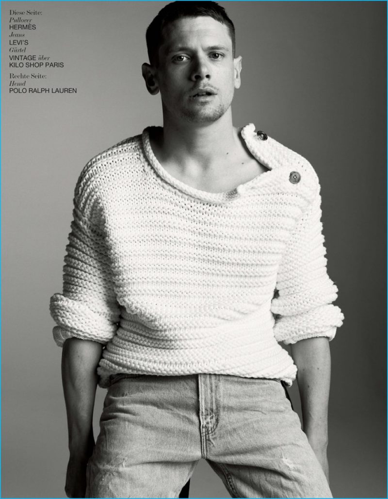 Jack O'Connell wears a standout sweater from Hermes with Levi's denim jeans.