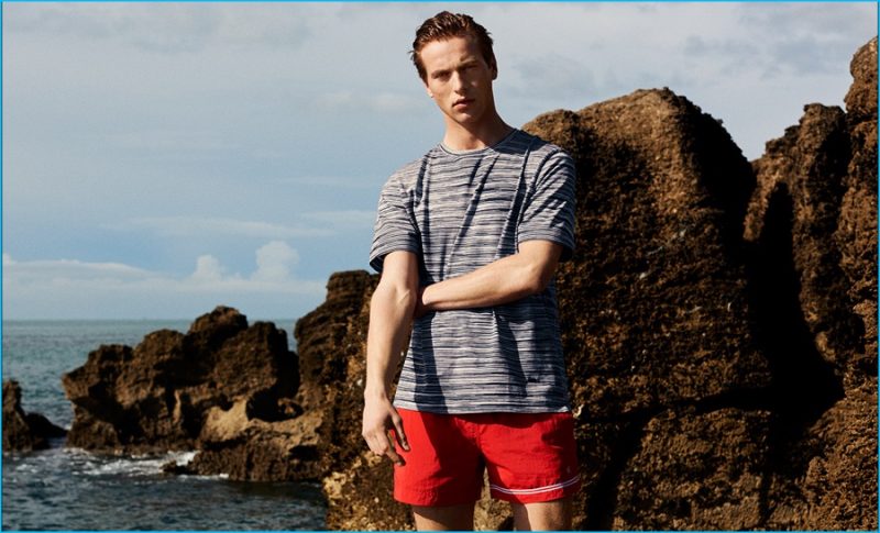 Jules Raynal wears multi-stripe cotton T-shirt by Missoni. Asymmetric-stripe swim shorts by Dan Ward.