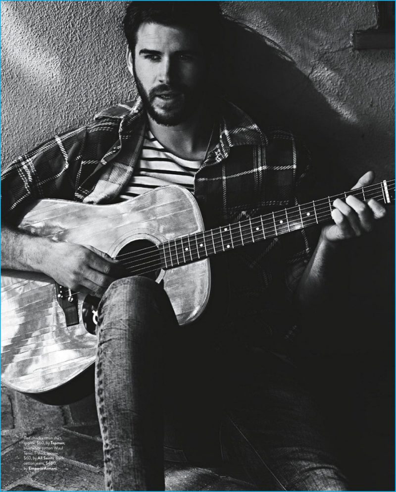 Liam Hemsworth plays the guitar, mixing prints in a check Topman shirt with a striped All Saints tee and Emporio Armani jeans.