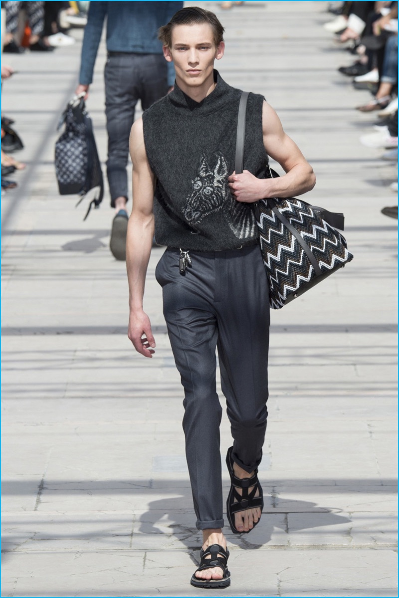 A model hits the catwalk for Louis Vuitton, wearing a sleeveless zebra adorned sweater from the fashion house's spring-summer 2017 collection.