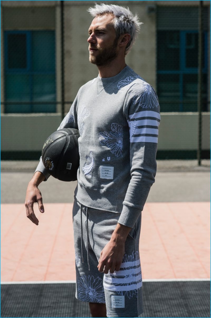 Matthew Foley goes sporty in a koi embroidery sweatshirt and sweatshorts from Thom Browne.