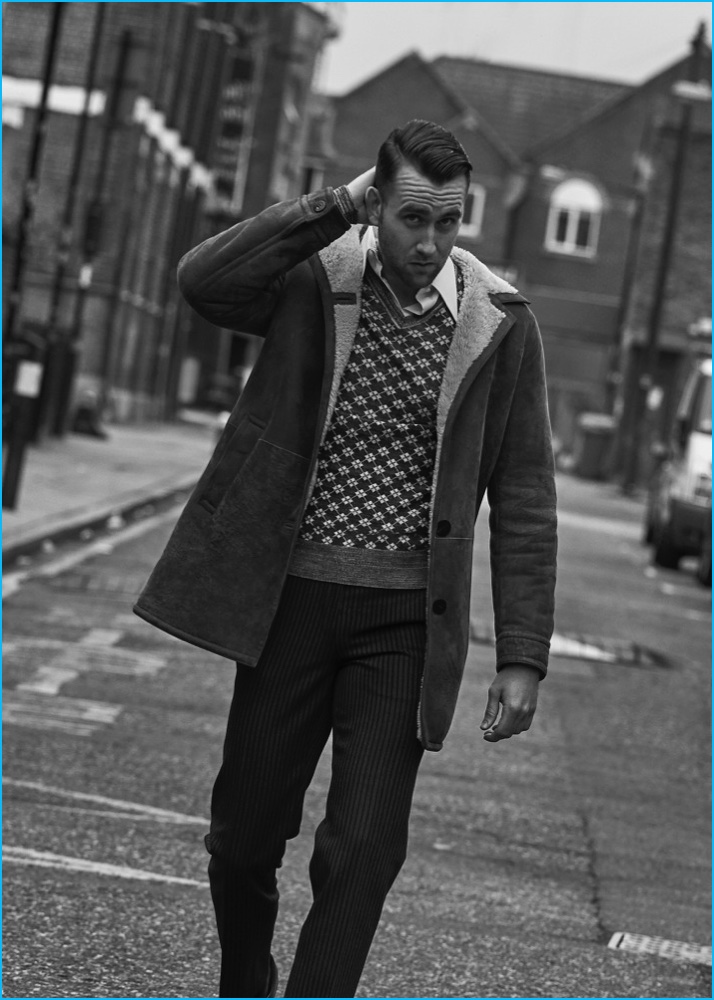 Matthew Lewis embraces a retro leaning in a Neil Barrett coat, worn over a Vivienne Westwood sweater with a shirt and trousers from Alexander McQueen.
