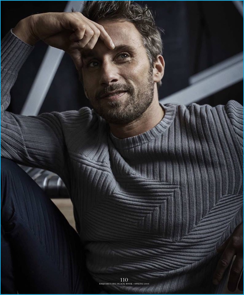 Matthias Schoenaerts poses for the pages of Esquire Big Black Book, wearing a grey ribbed sweater.