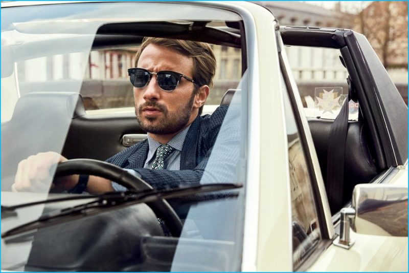 Matthias Schoenaerts connects with American GQ donning a Hermes suit with Persol sunglasses.
