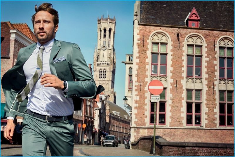 Warming up to green, Matthias Schoenaerts is pictured on the run, wearing a H American Tailor suit.