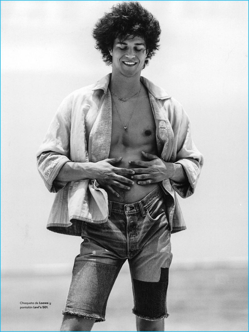 Miles McMillan takes to the beach in a Loewe jacket with Levi's denim shorts.
