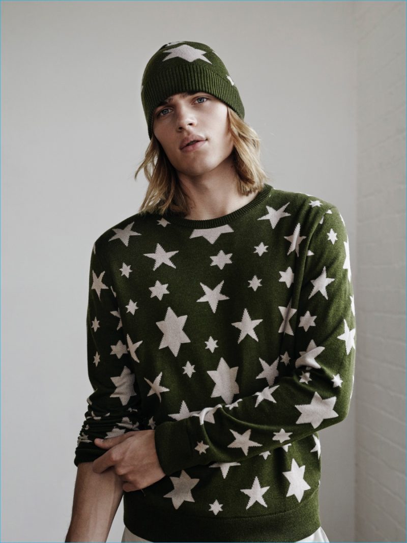 Ton wears a star print knit sweater and beanie from YMC x River Island collection.